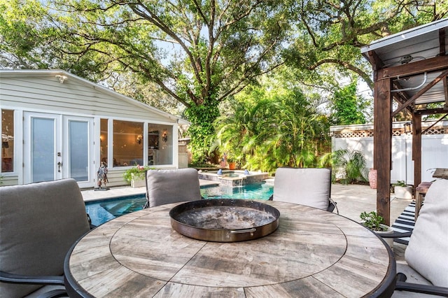 wooden terrace with a swimming pool with hot tub and a patio area