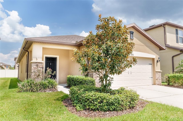 view of front of house featuring a garage and a front lawn