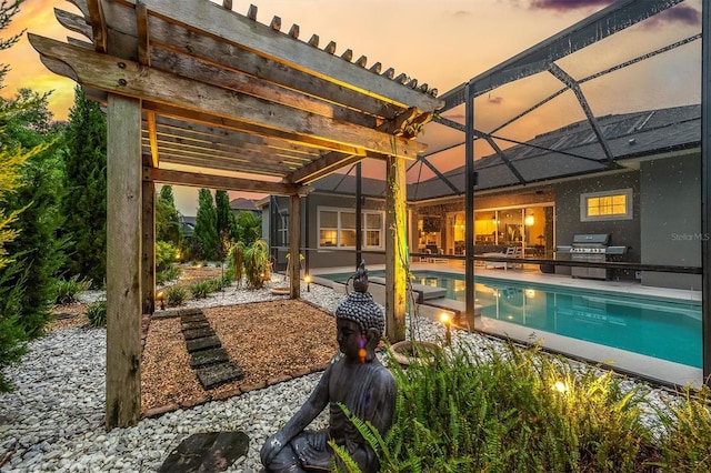 pool at dusk with a lanai, a pergola, exterior kitchen, a patio, and grilling area