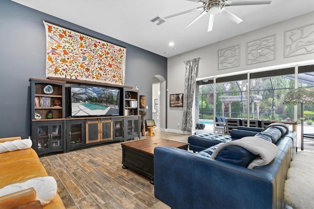 living room with hardwood / wood-style floors and ceiling fan