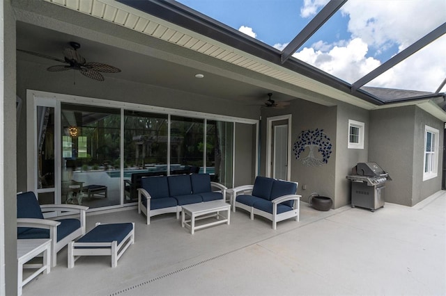 view of patio / terrace with grilling area, glass enclosure, ceiling fan, and an outdoor hangout area