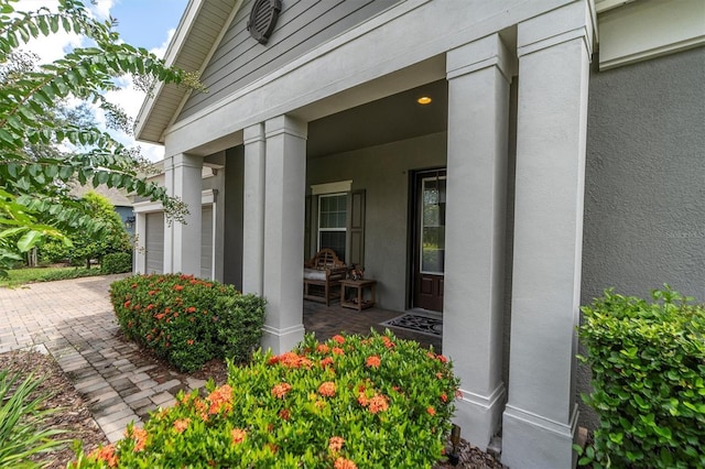 entrance to property with a garage and a porch