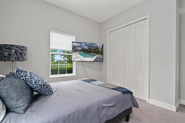 bedroom featuring a closet and light carpet