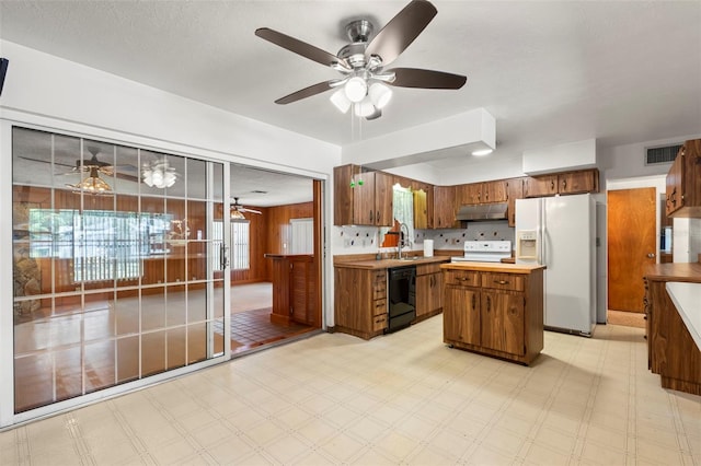 kitchen with light tile patterned flooring, sink, white appliances, ceiling fan, and hanging light fixtures