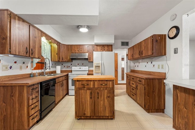 kitchen featuring sink, white appliances, and light tile patterned floors