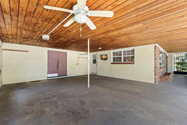 garage featuring wooden ceiling and ceiling fan