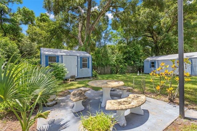 view of yard featuring a storage unit and a patio area