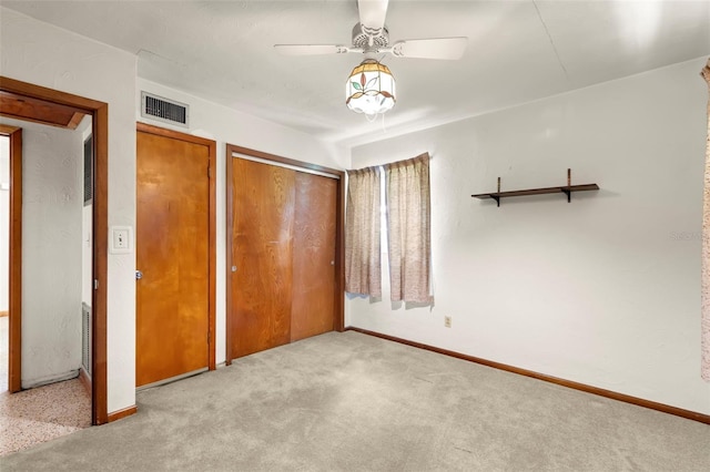 unfurnished bedroom featuring ceiling fan and light carpet