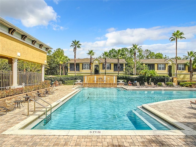 view of pool featuring pool water feature and a patio area