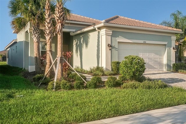 mediterranean / spanish-style home featuring a garage and a front lawn