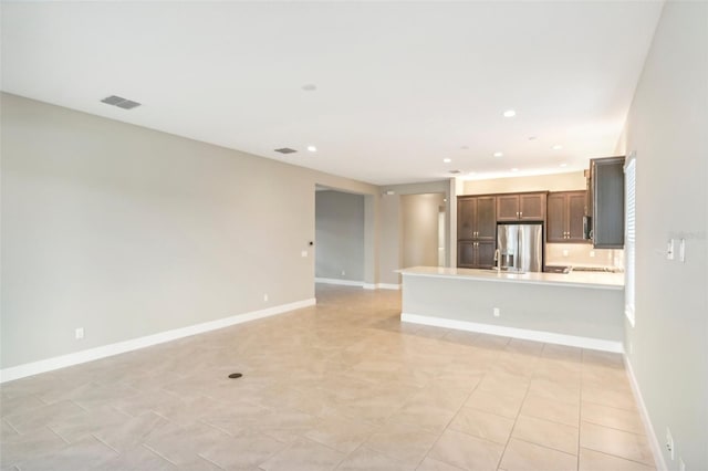 unfurnished living room featuring light tile patterned floors