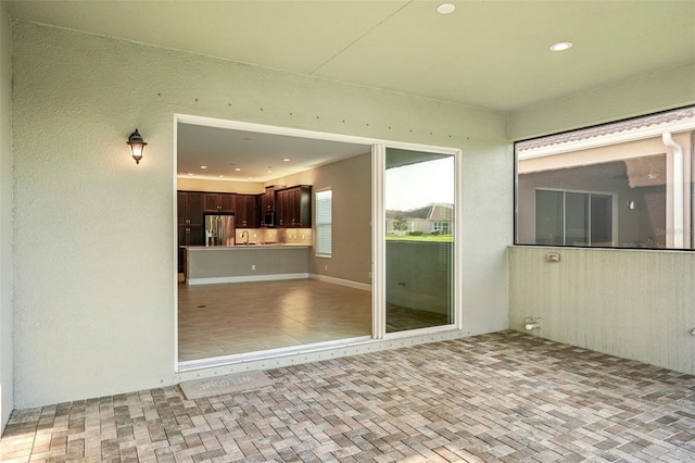 spare room with sink and light tile patterned floors