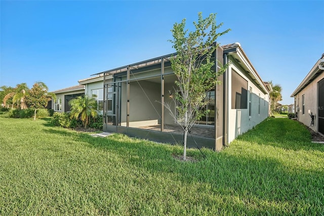 rear view of property with a lawn