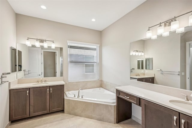 bathroom featuring vanity, tiled tub, and tile patterned floors