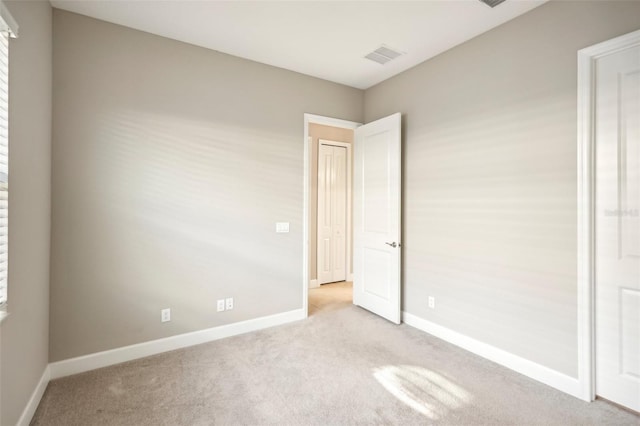 unfurnished bedroom with light colored carpet