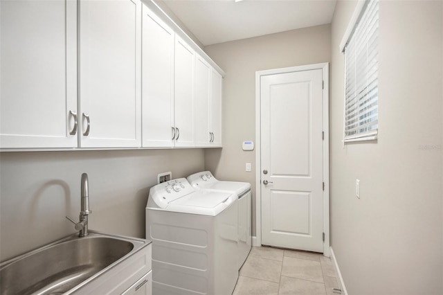 laundry area featuring sink, cabinets, washing machine and clothes dryer, and light tile patterned flooring