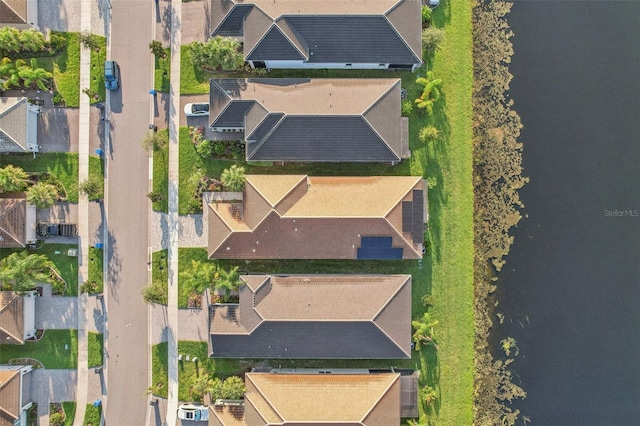 birds eye view of property featuring a water view