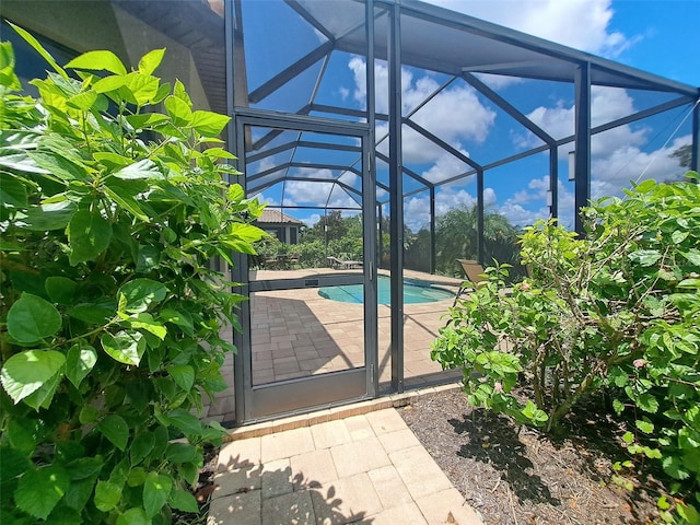 view of patio with glass enclosure