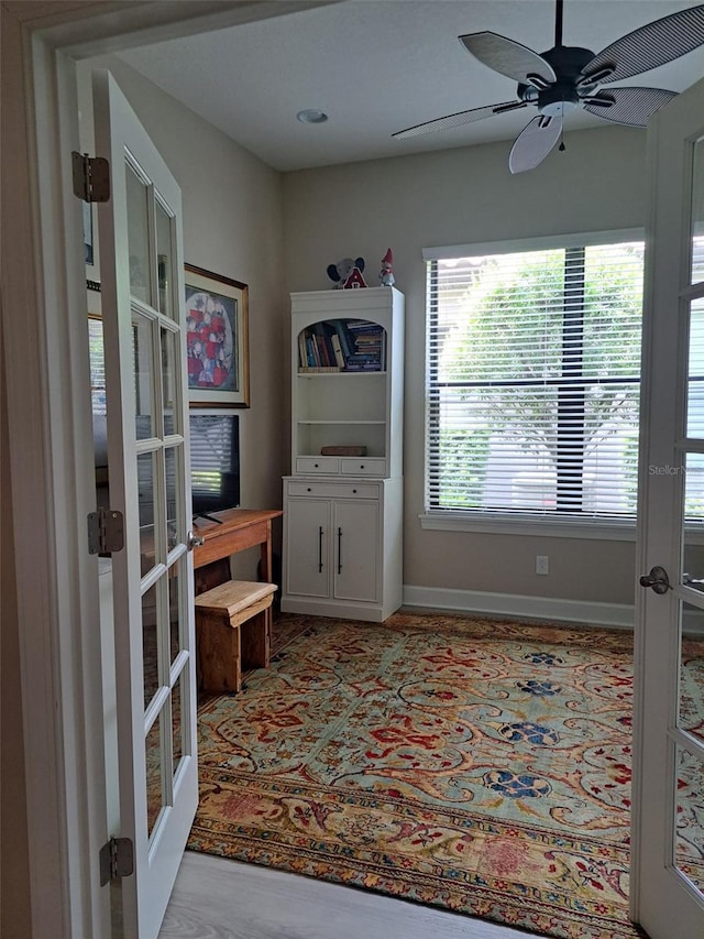 interior space with french doors and ceiling fan