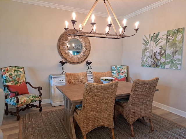 dining room with crown molding, hardwood / wood-style flooring, and an inviting chandelier