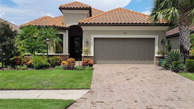 mediterranean / spanish home featuring a garage and a front yard