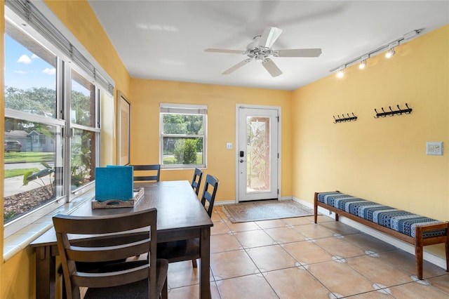 dining area with ceiling fan, track lighting, and light tile patterned flooring