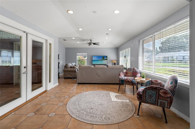 tiled living room featuring ceiling fan and french doors