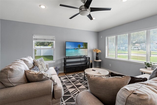 living room with ceiling fan, a healthy amount of sunlight, and hardwood / wood-style floors