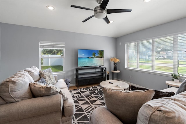 living room with a healthy amount of sunlight, ceiling fan, baseboards, and recessed lighting