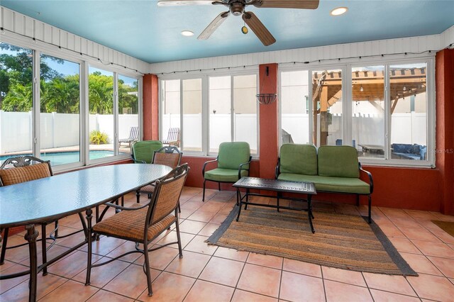 sunroom / solarium featuring a ceiling fan