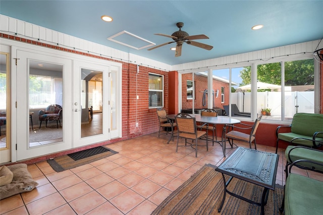 sunroom / solarium with ceiling fan, plenty of natural light, and french doors