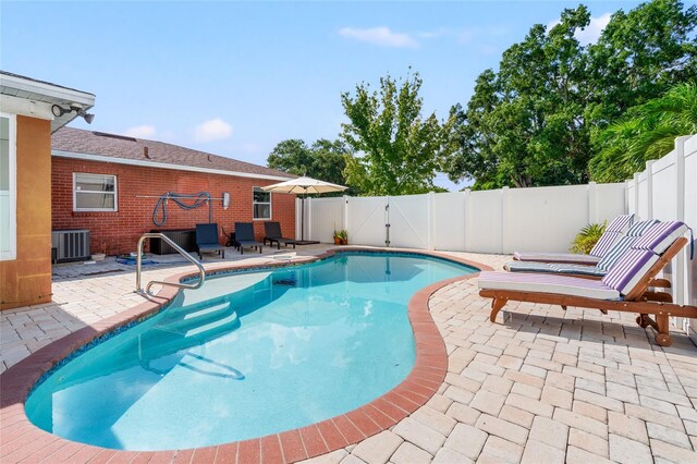 view of swimming pool with a patio area, a fenced backyard, a gate, and a fenced in pool