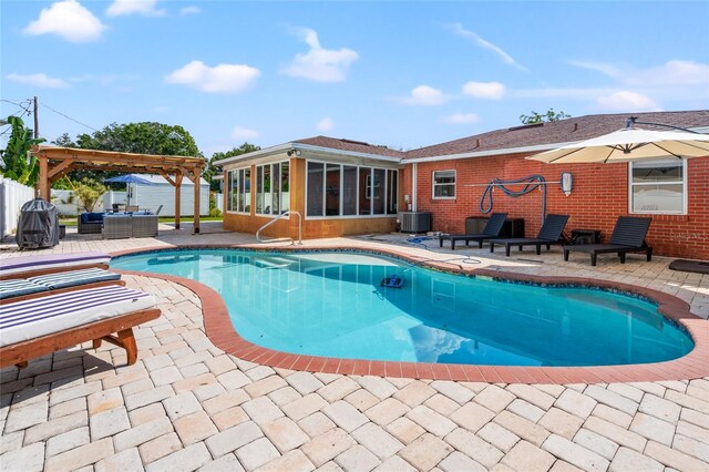 view of pool with a pergola, a patio, and central AC