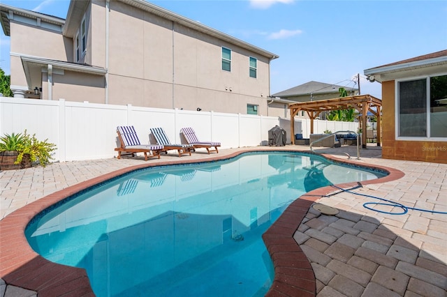 view of swimming pool featuring a patio area and a pergola