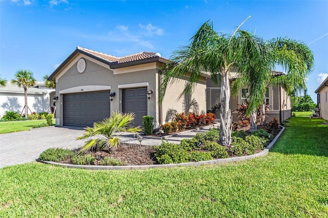 view of front of property with a front yard and a garage