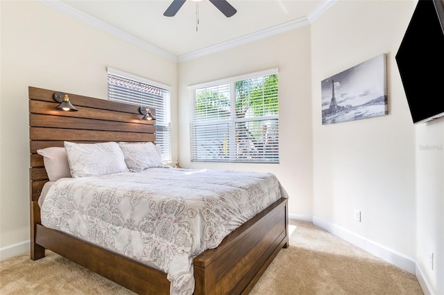 bedroom with crown molding, ceiling fan, and light carpet