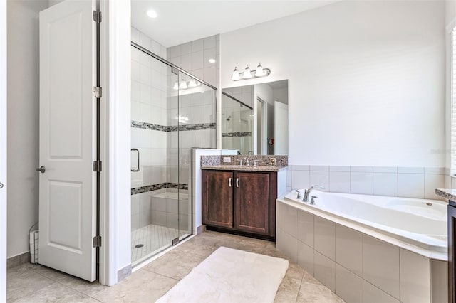 bathroom featuring tile patterned flooring, vanity, and independent shower and bath