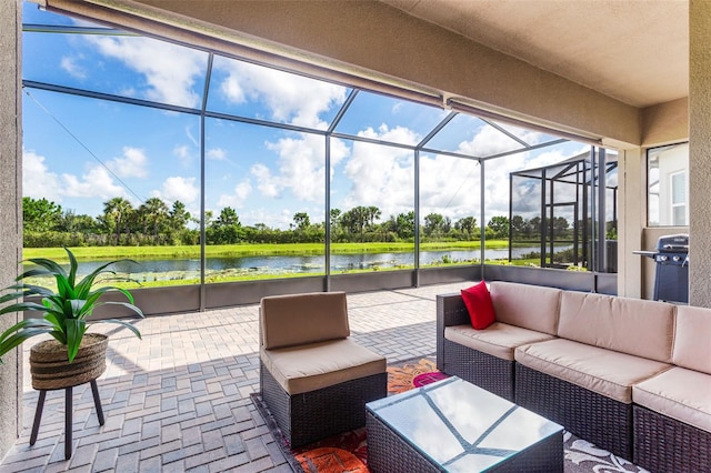 sunroom / solarium featuring a water view