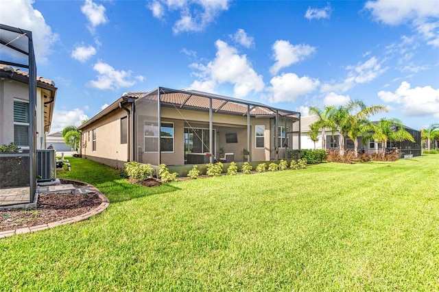 back of property featuring a lawn, glass enclosure, and central air condition unit