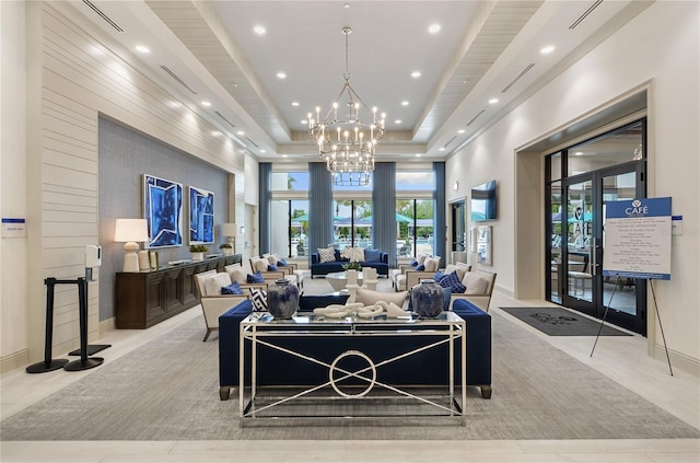 living room featuring a tray ceiling and a chandelier