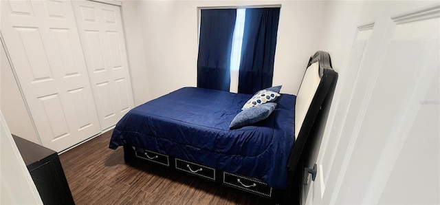 bedroom featuring a closet and dark hardwood / wood-style floors