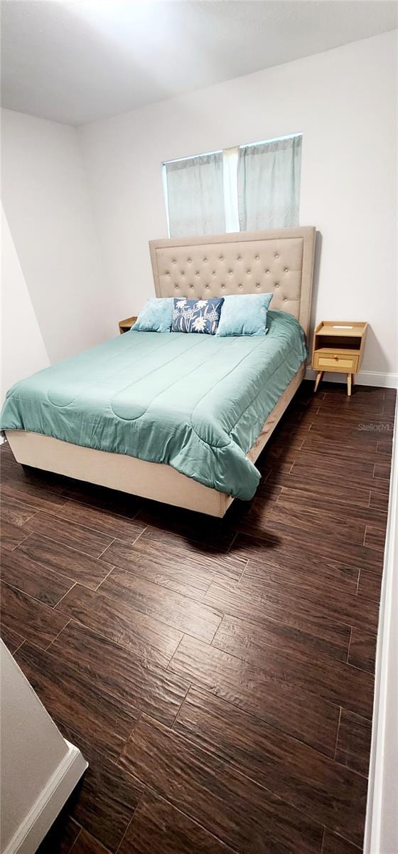 bedroom featuring dark wood-type flooring