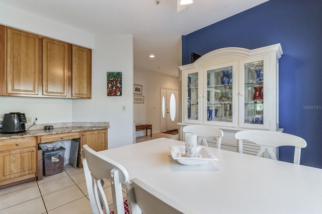 dining space featuring light tile patterned flooring