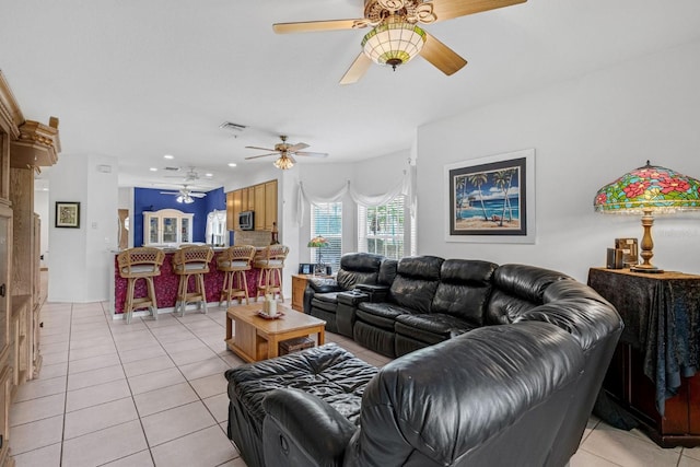 living room with light tile patterned floors and ceiling fan