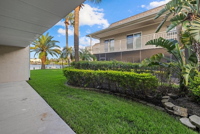 view of yard with a balcony