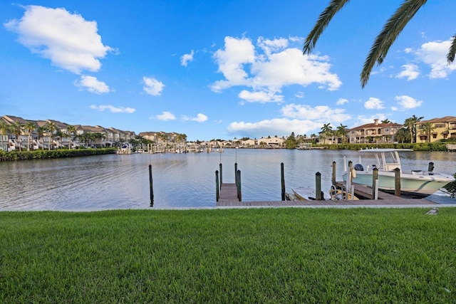 dock area with a water view and a yard