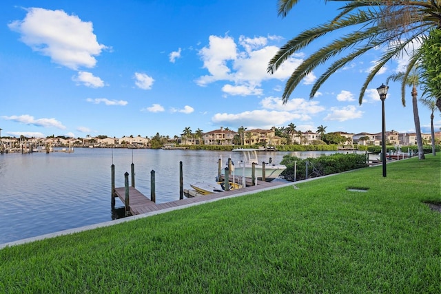 dock area featuring a yard and a water view