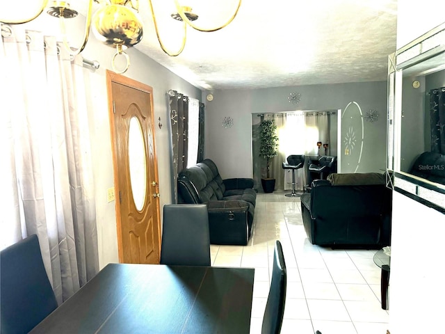 interior space with a wealth of natural light, light tile patterned floors, and a textured ceiling