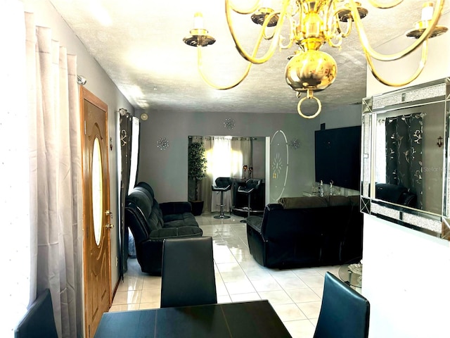 living room with light tile patterned floors, a notable chandelier, and a textured ceiling