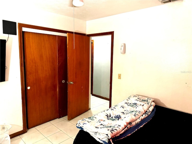 tiled bedroom featuring a closet